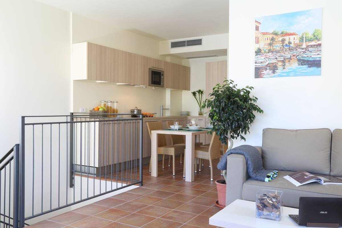 A modern apartment with a kitchen, dining area, and living room.