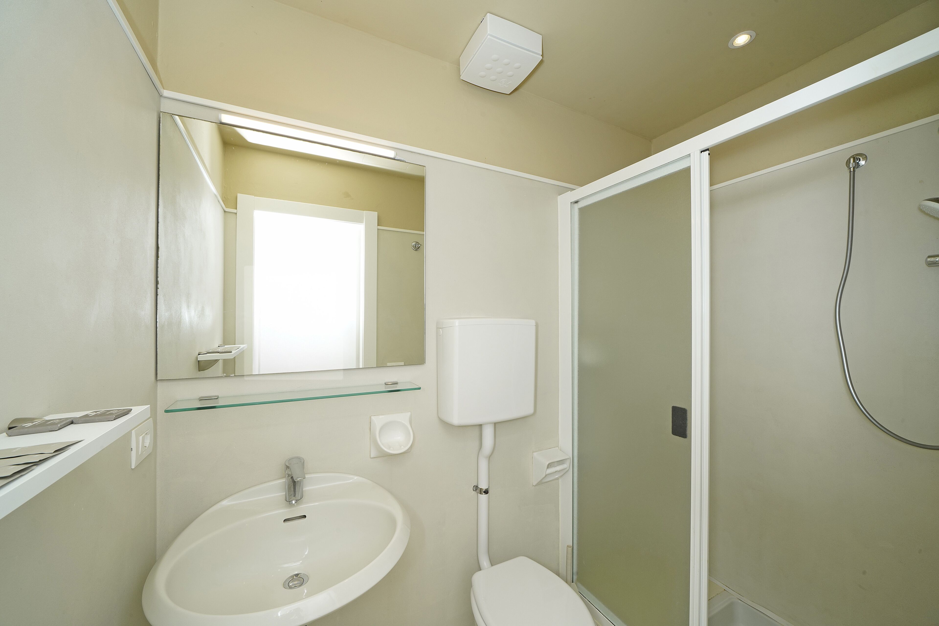 A bathroom with a sink, toilet, and shower.