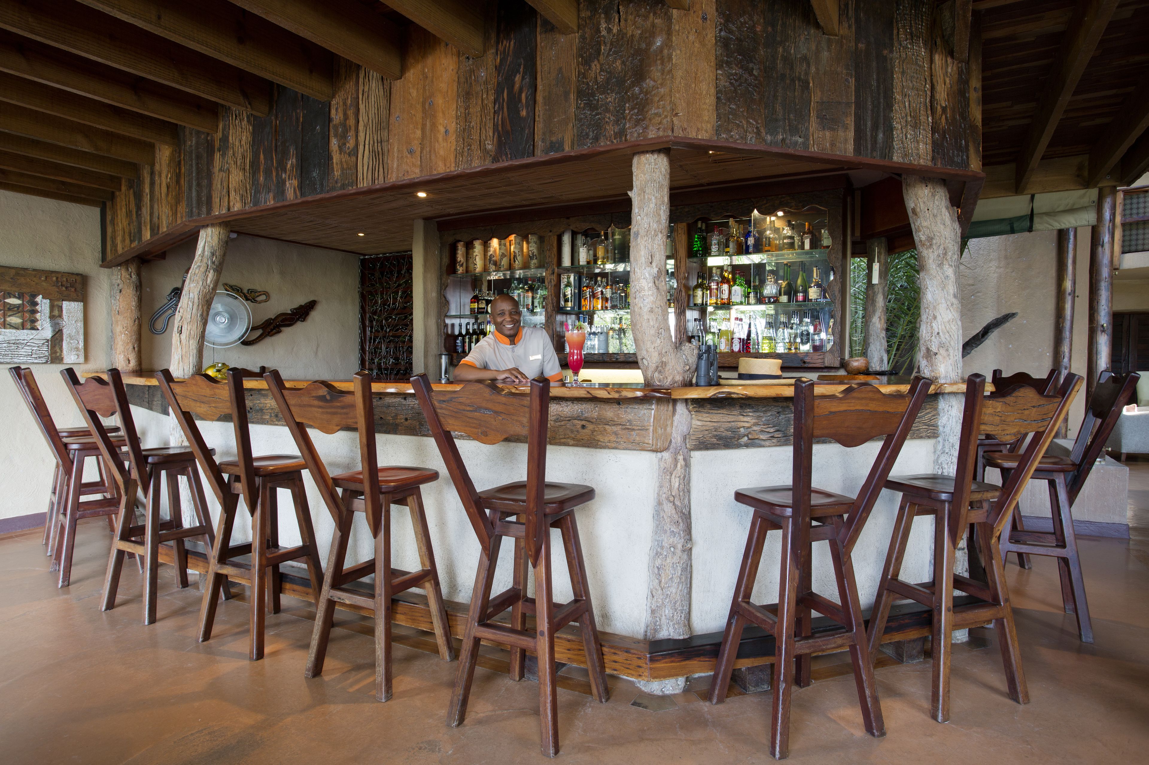 A bar area with wooden chairs and a bar counter.