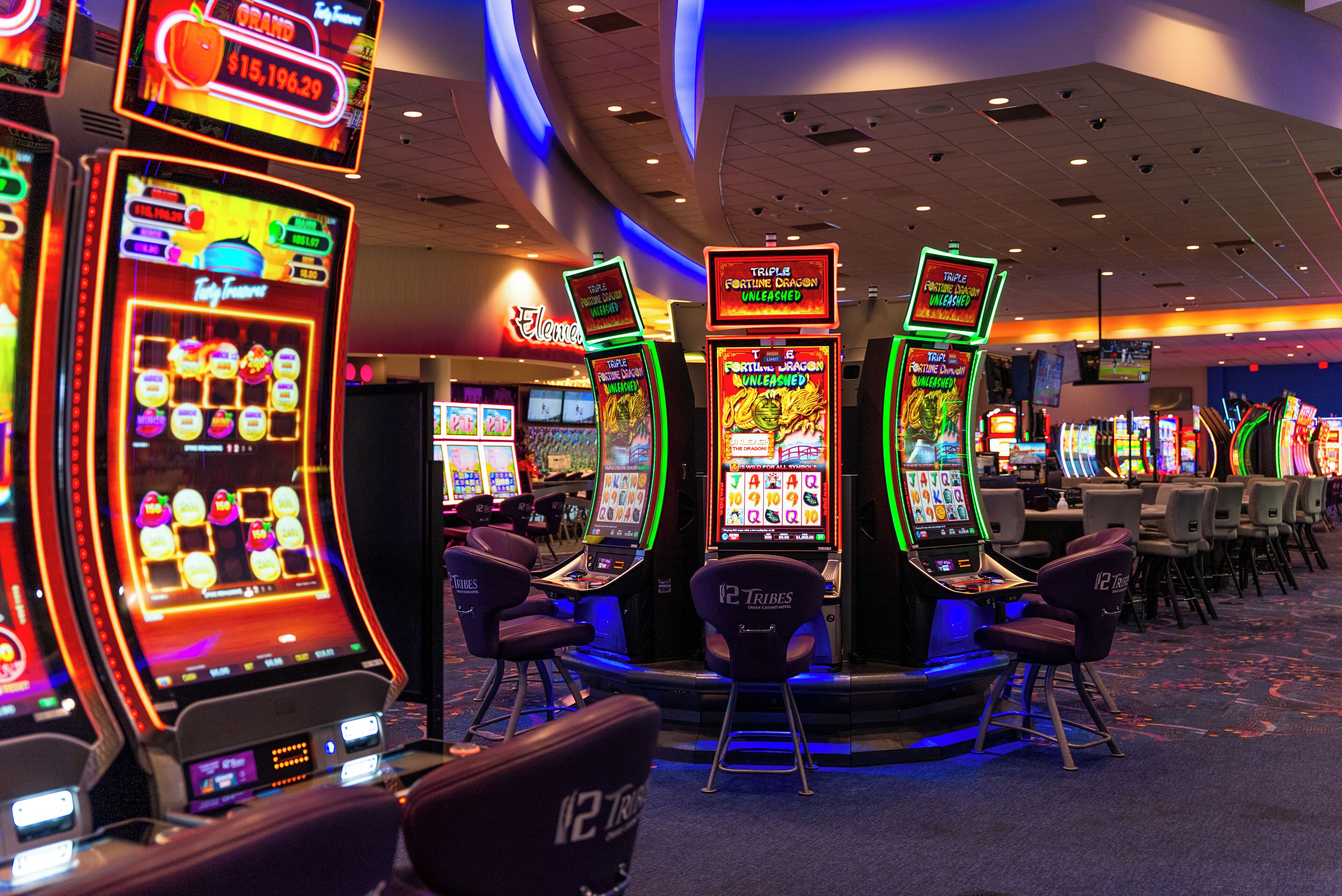 A casino floor with slot machines and gaming tables.