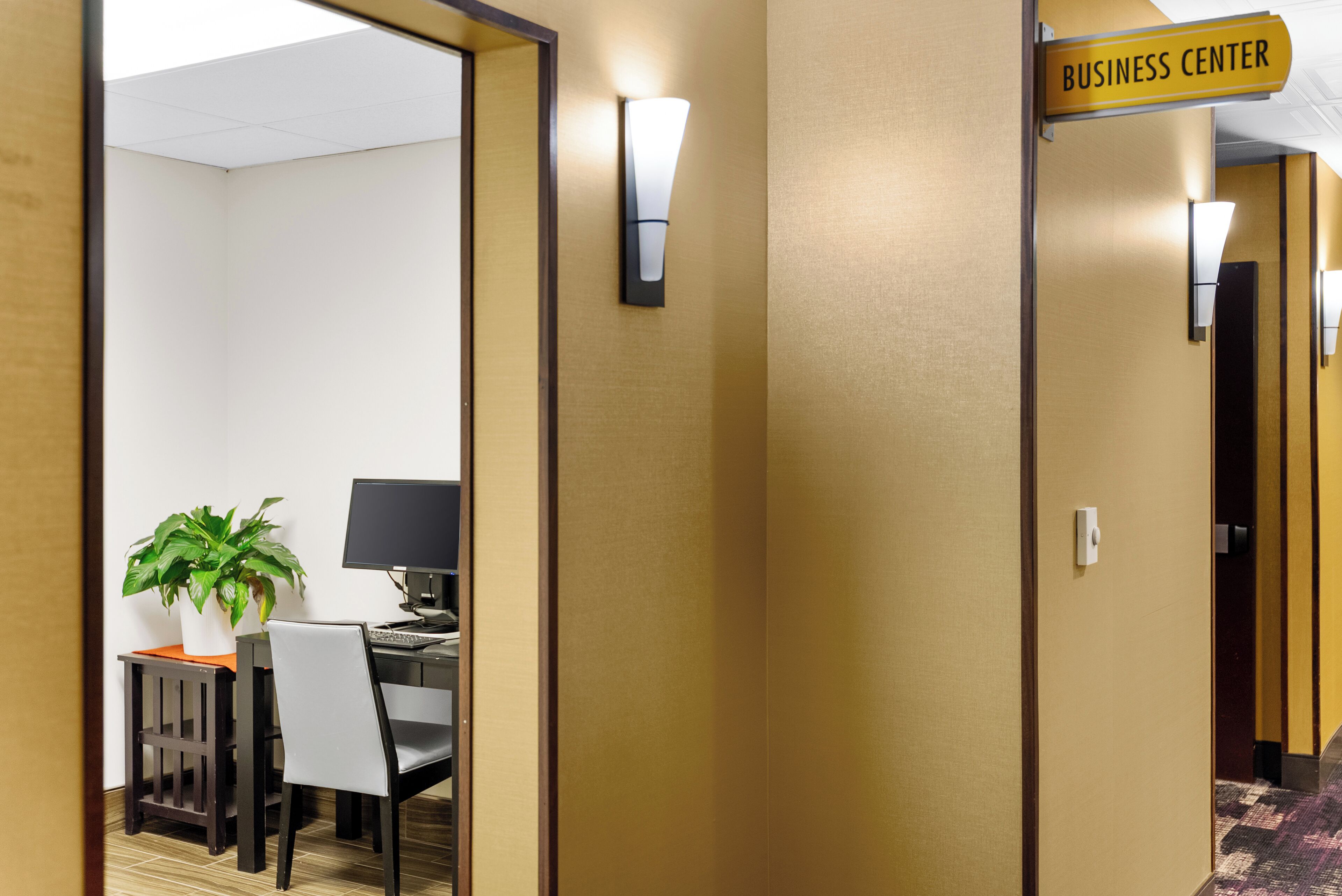 A hotel hallway with a sign indicating the Business Center.