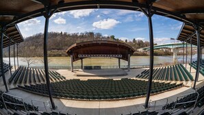 An amphitheater with tiered seating and a stage, overlooking a body of water and a bridge. - Candlewood Suites MORGANTOWN-UNIV WEST VIRGINIA by IHG (Morgantown)