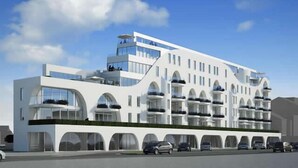 A modern multi-story hotel with a white facade, large windows, and balconies. - White Princess (Koksijde)
