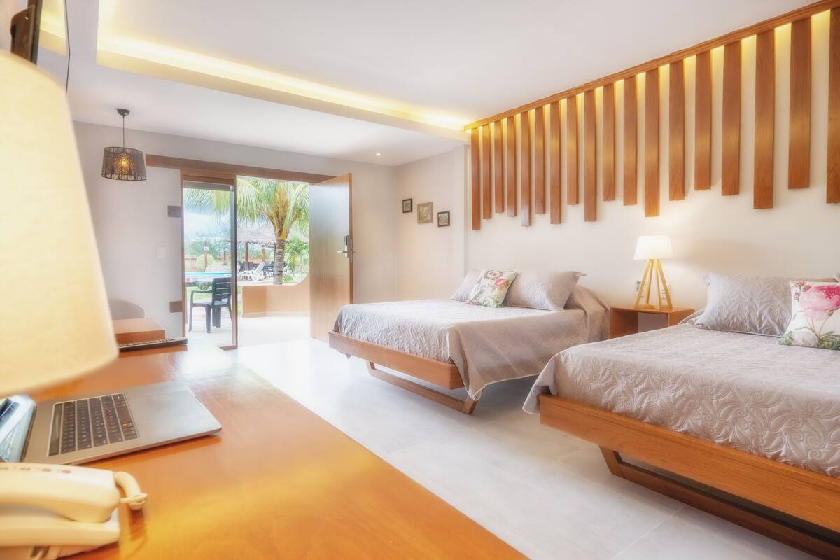 Deluxe Room | Minibar, in-room safe, laptop workspace, blackout curtains