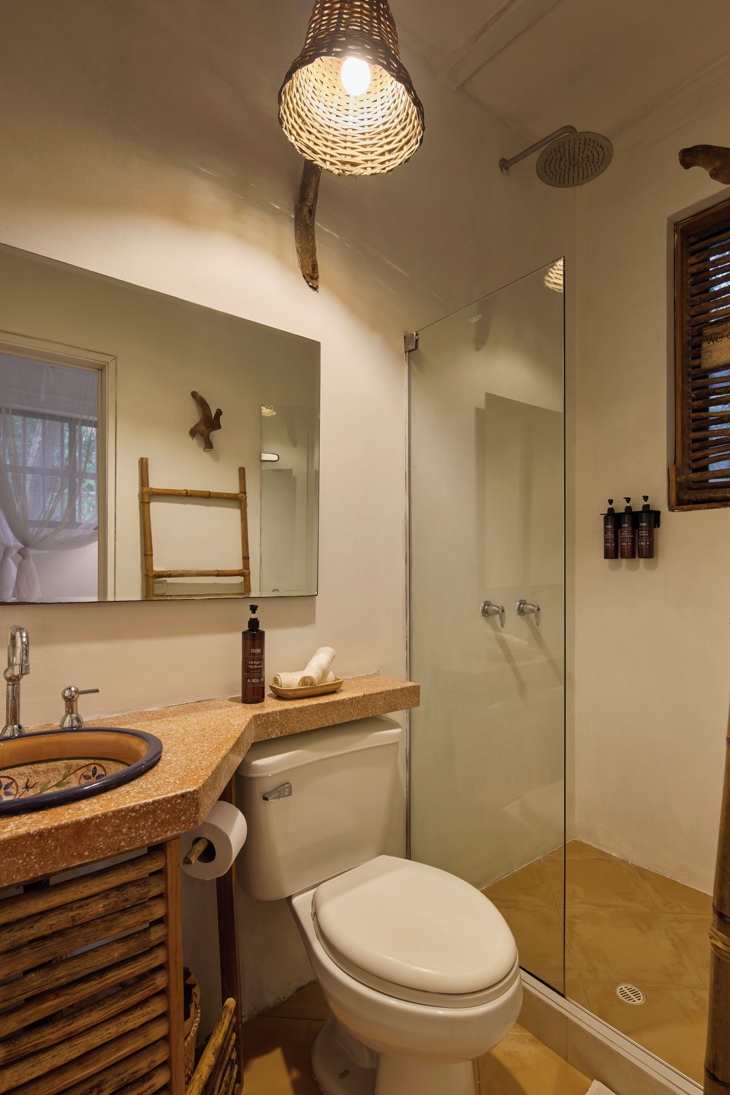A bathroom with a toilet, sink, and shower.