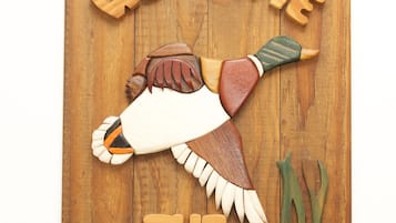A wooden sign with carved figures and the text "WELCOME THE CAREYS".