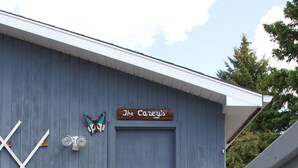 A wooden building with a sign reading "The Carters." - Cozy Nest B&B (Calgary)