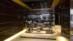 A modern interior with a reception desk, two chairs, and a small table. -  Lahoya Beirut (Beirut)