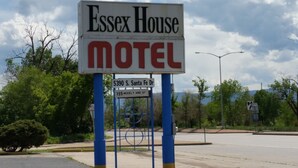 A motel sign with the name 'Essex House' and 'Motel' written on it, along with the address '5390 S. Santa Fe Dr' and a note '199 weekly and up'. - Essex House Motel (Littleton)