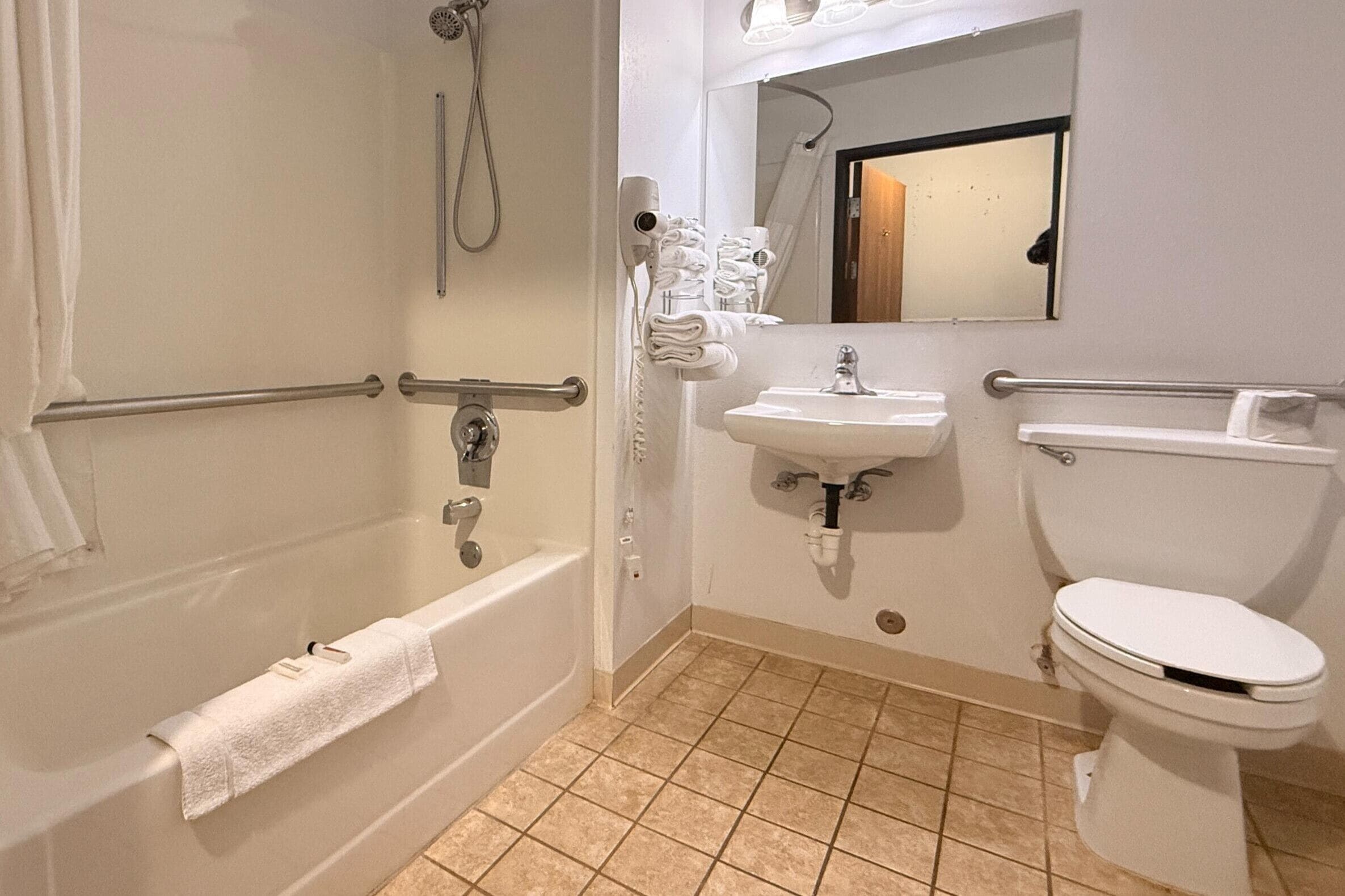 A bathroom with a bathtub, a sink, and a toilet.