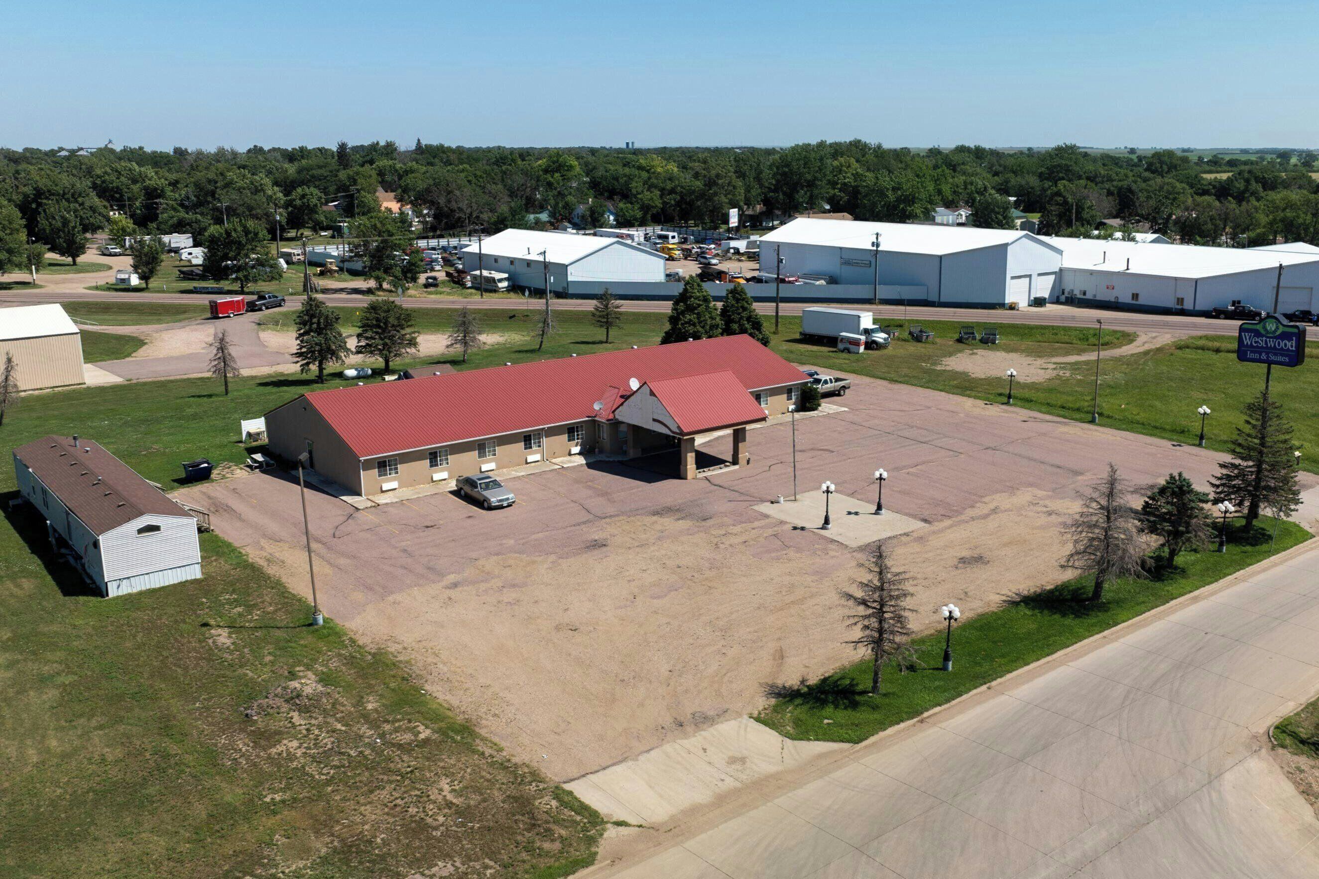 A large industrial area with multiple buildings, including a prominent red-roofed structure.