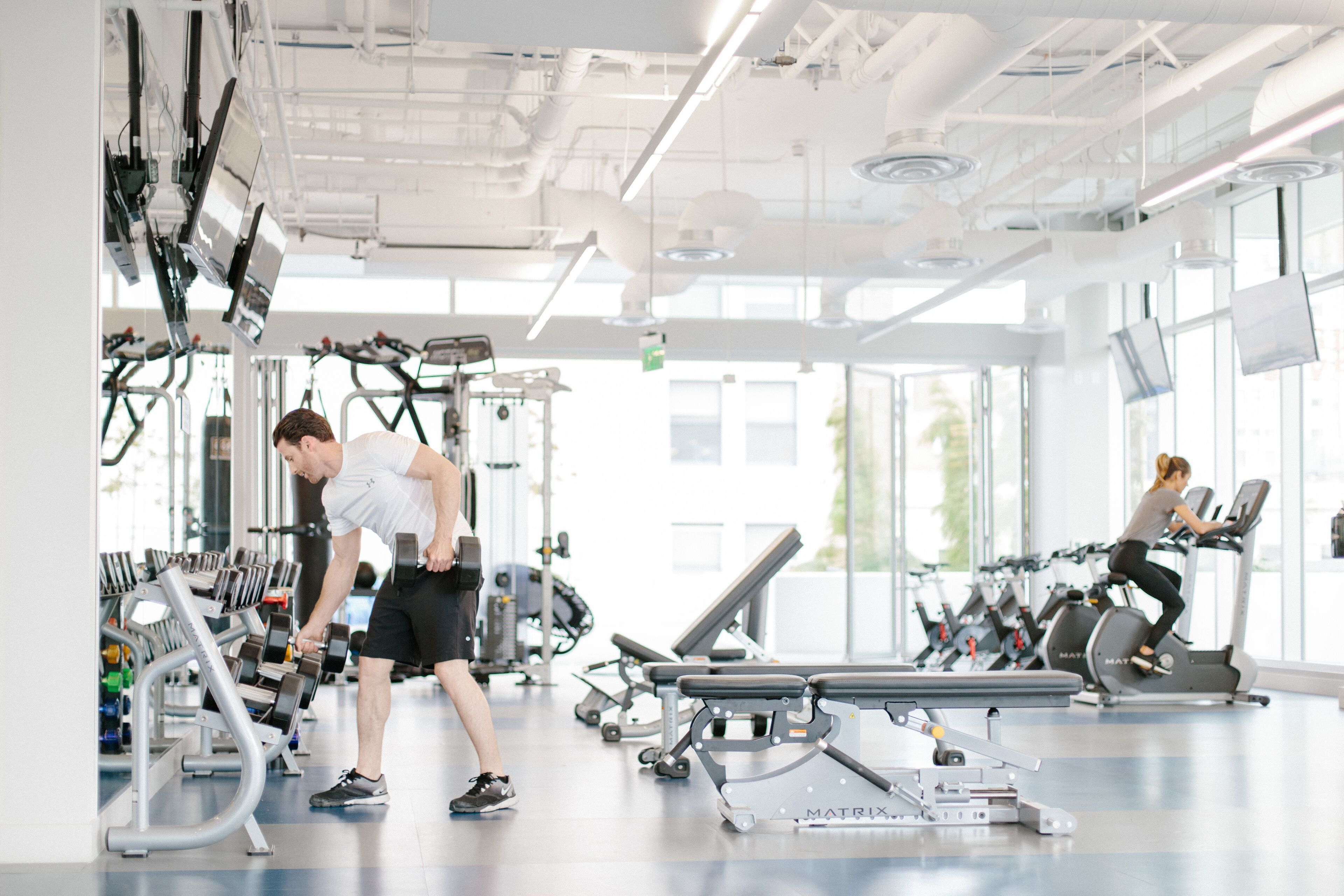 A gym with various exercise equipment, including treadmills and weight machines.