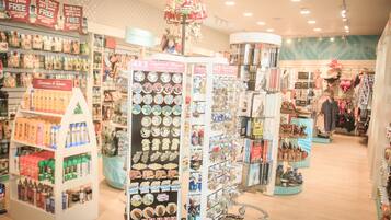 A well-lit store with various shelves stocked with products, including snacks, beverages, and decorative items.