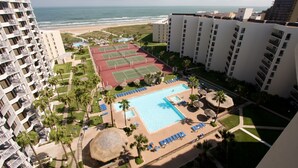 A resort with a large swimming pool, tennis courts, and a beach view. - Saida by South Padre Condo Rentals (South Padre Island)