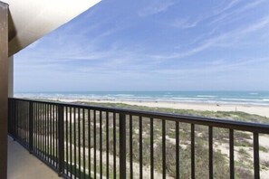 A balcony with a view of a beach and ocean. - Sea Vista by South Padre Condo Rentals (South Padre Island)