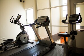 A gym with two stationary bikes and a treadmill. - Copper Canyon Boutique Hotel (Chihuahua)