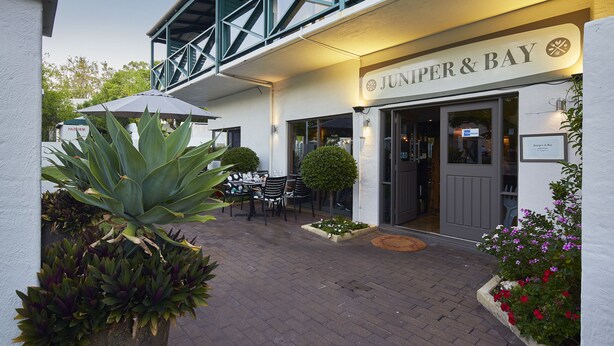 A building with a sign reading "Juniper & Bay".