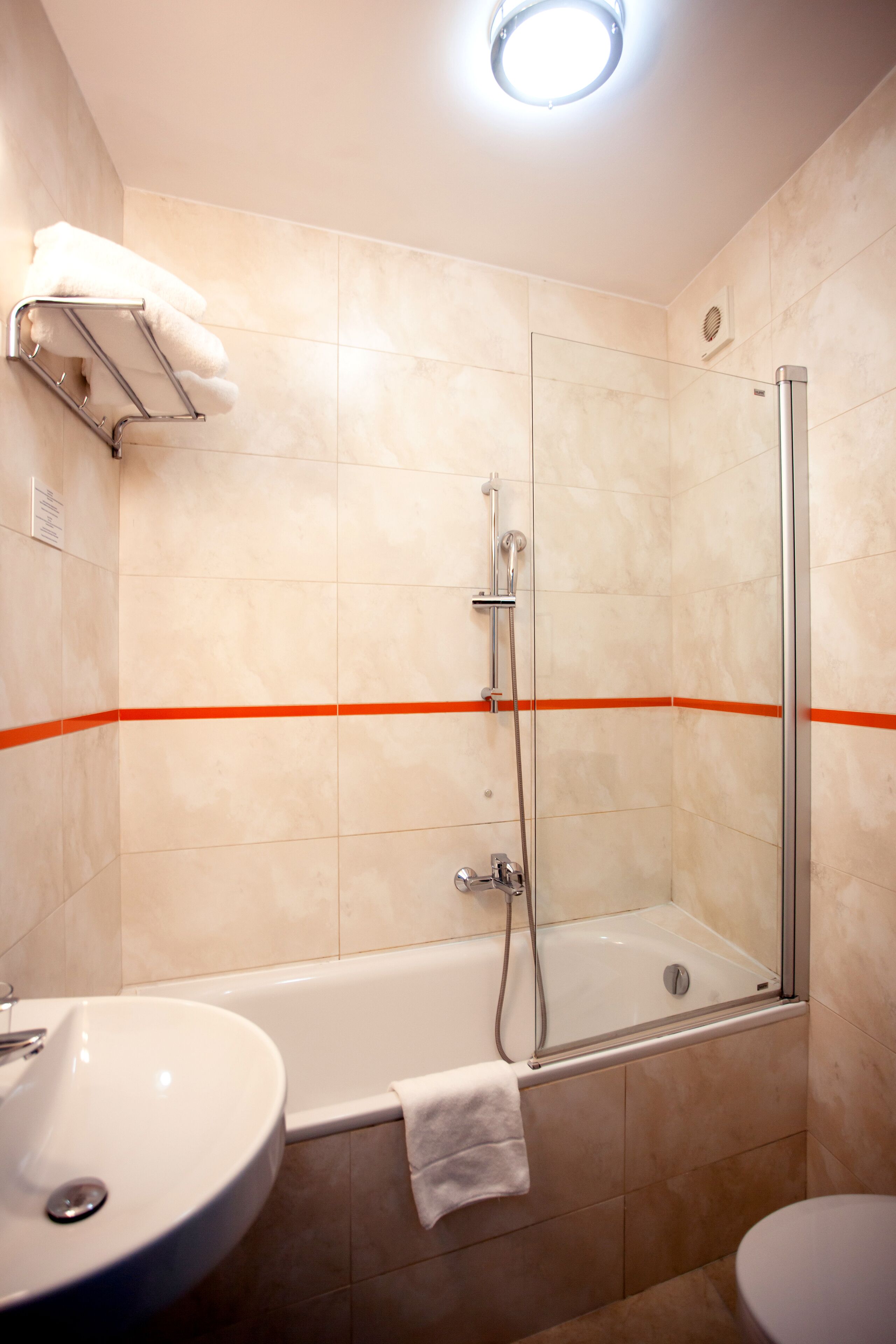 A bathroom with a bathtub, a sink, and a toilet.
