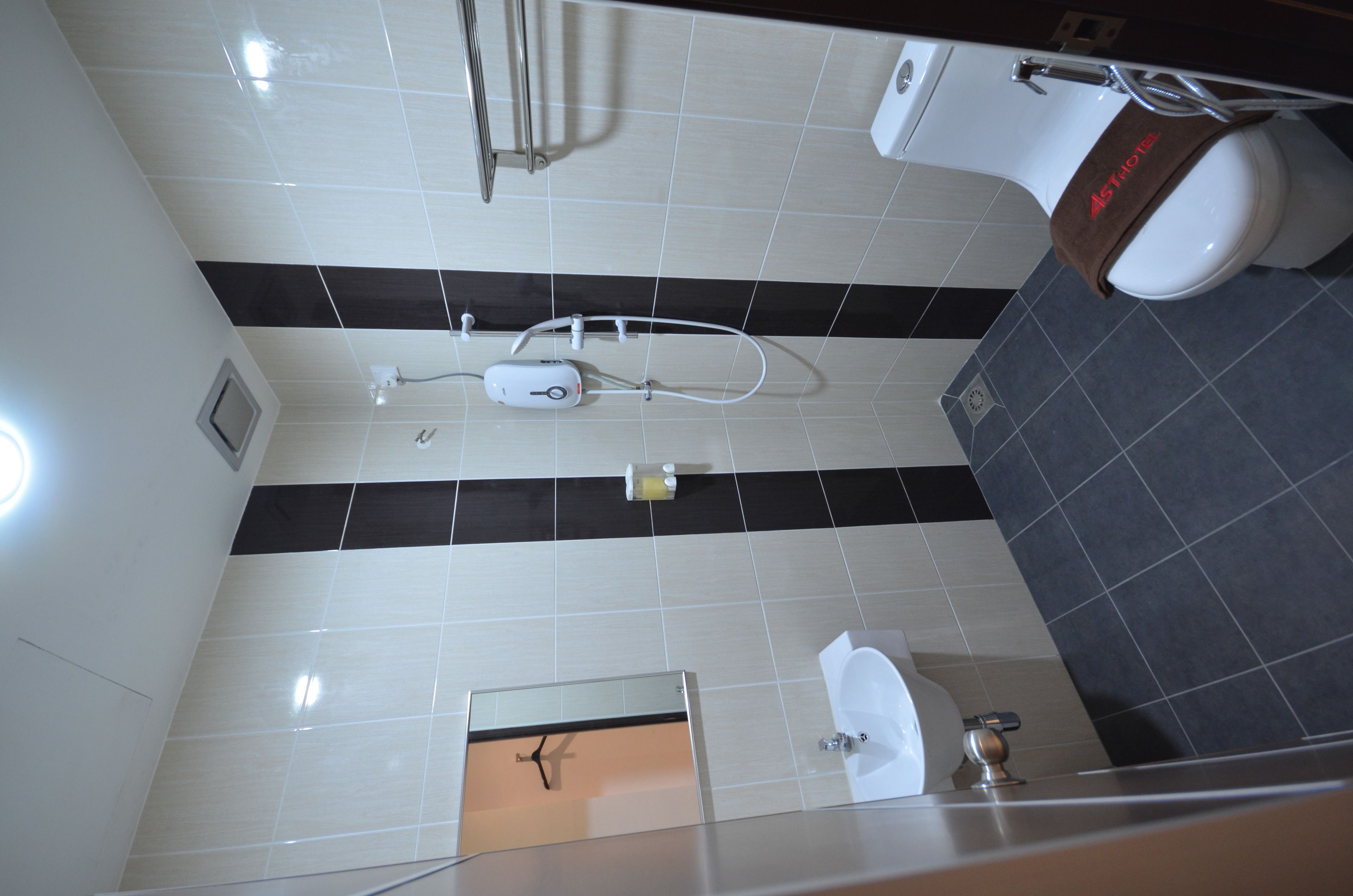 A modern bathroom with a toilet, bidet, and sink.