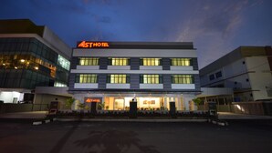 A modern hotel with a glass facade, multiple floors, and a prominent 'Ast Hotel' sign. - AST Hotel (Alor Setar)