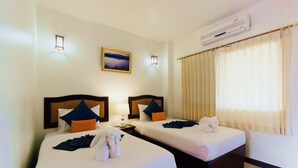 A hotel room with two beds, a painting on the wall, an air conditioning unit, and a window with curtains. - Namkhong Riverside Hotel Chiang Rai (Chiang Khong)