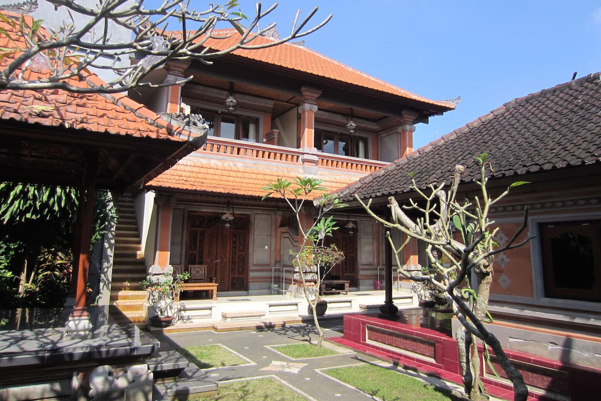 A traditional building with a tiled roof, a central courtyard, and a small garden area.
