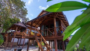 A wooden structure with multiple levels and staircases, surrounded by greenery. - Lipe Beach Resort (Koh Lipe)