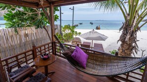 A hammock chair with cushions, wooden furniture, and a view of the beach and ocean. - Lipe Beach Resort (Koh Lipe)