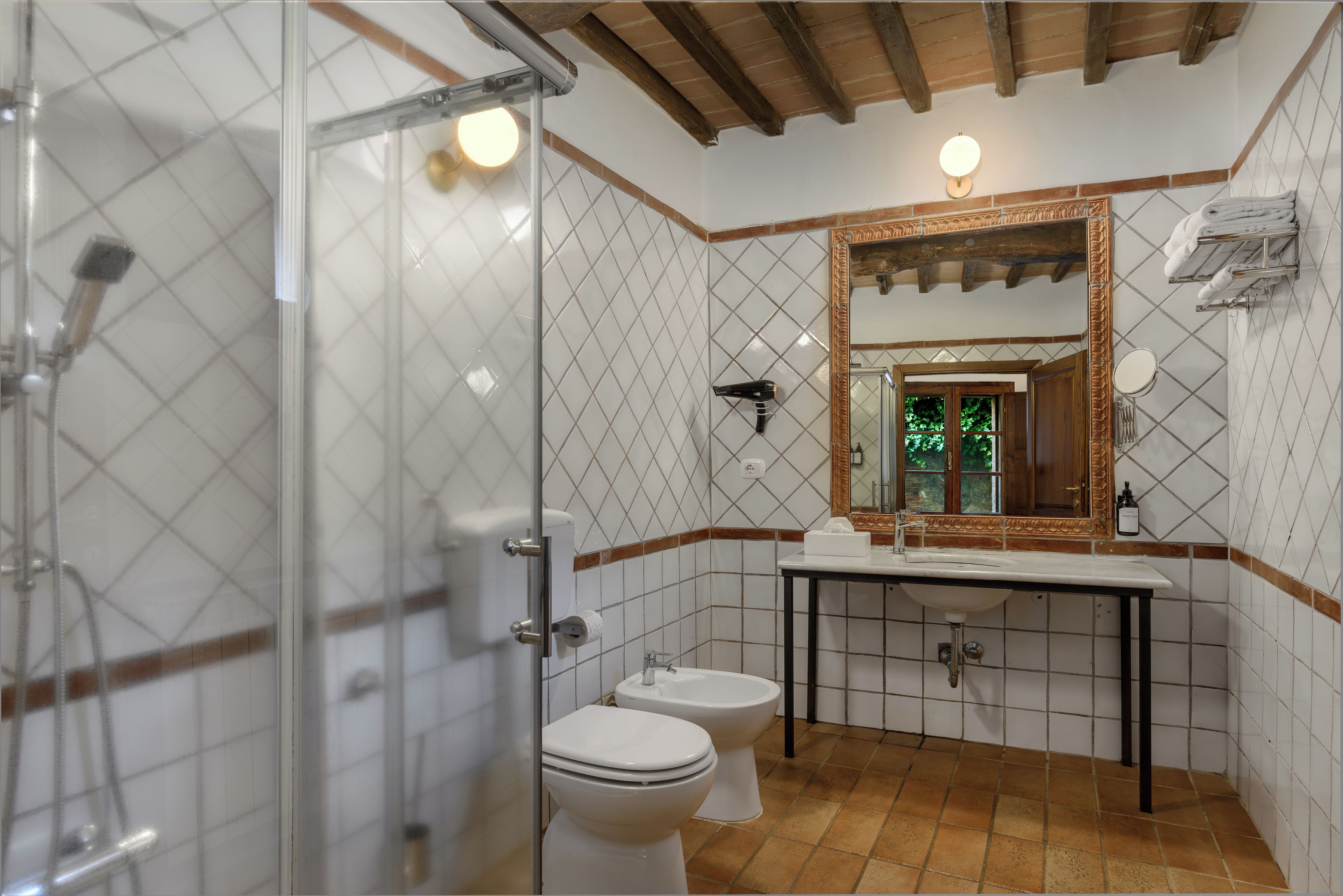 A bathroom with a shower, toilet, and sink.