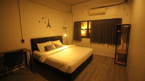 A hotel room with a bed, bedside table, lamp, and a wardrobe. - The Hive Hatyai Hostel (Hat Yai)