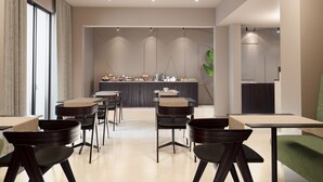 A modern dining area with a central bar, multiple seating options, and a large window providing natural light. - Mariette Rhodes Urban Suites  (Rhodes)