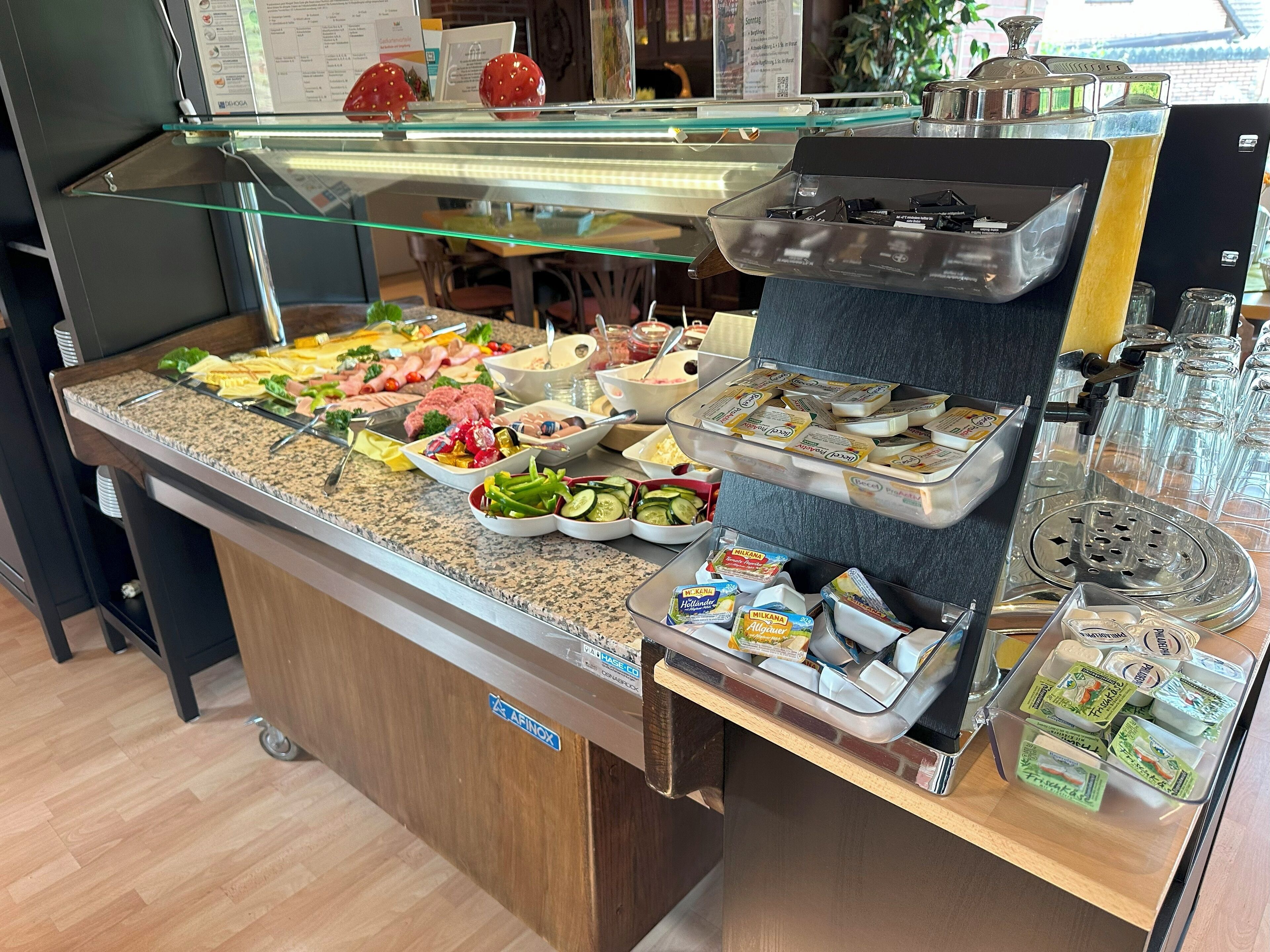 A buffet with various food items and condiments.