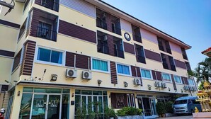 A multi-story hotel with a modern design, featuring a flat roof, large windows, and a visible entrance with a glass door. - The Avail (Ayutthaya)