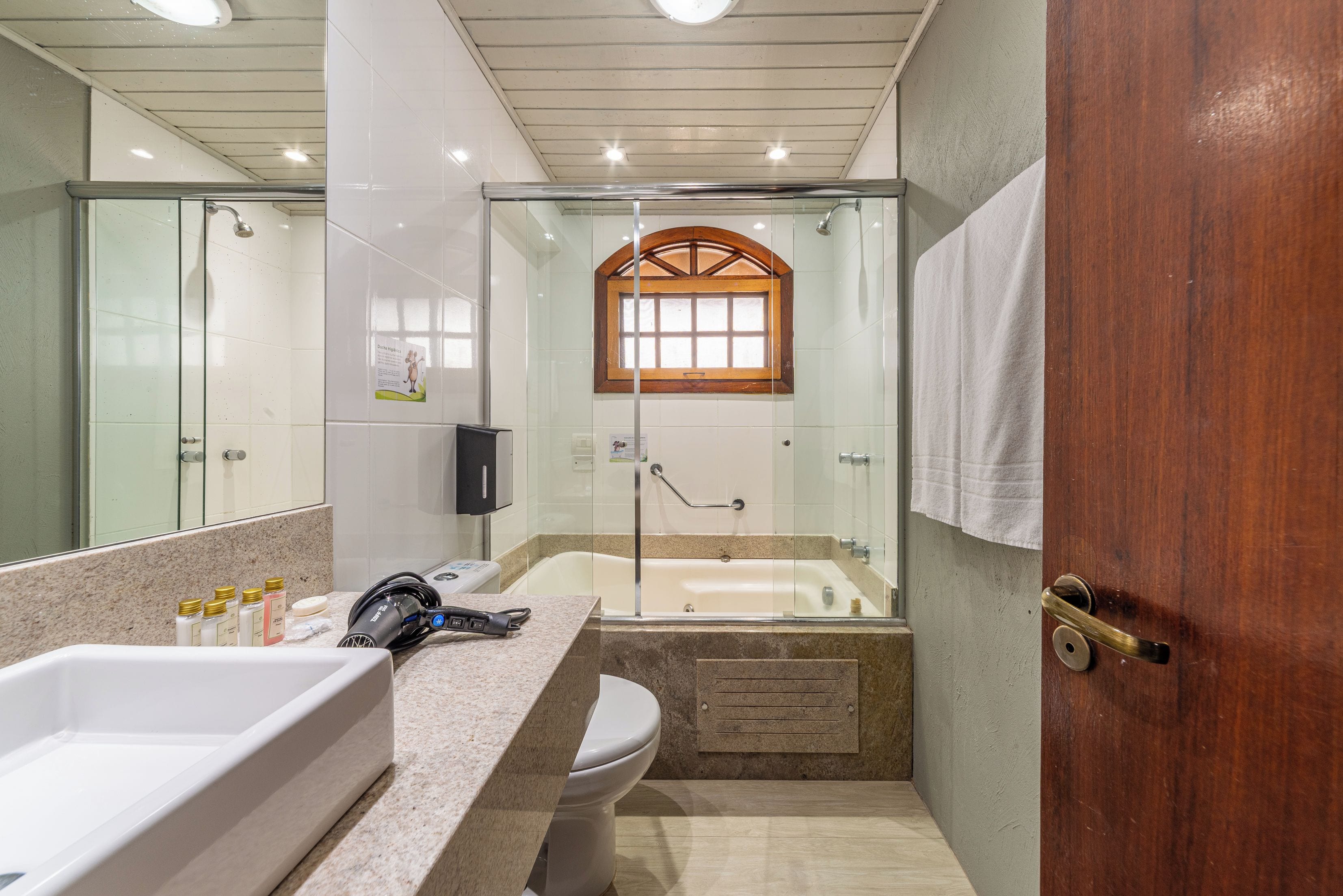 A bathroom with a bathtub, a shower, a toilet, and a sink.