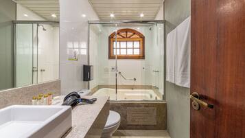 A bathroom with a bathtub, a shower, a toilet, and a sink.