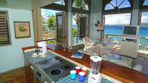 A kitchen with a view of the ocean, a blender, and a coffee maker. - Suite St. John at Gallows Point Resort (St. John)
