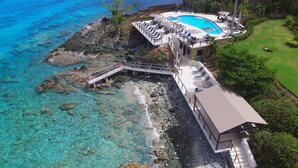 A resort with a swimming pool, a covered deck, and a view of the ocean. - Suite St. John at Gallows Point Resort (St. John)