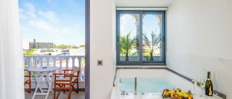 Executive Suite With Hot Tub | Bathroom | Shower, rainfall showerhead, hair dryer, towels