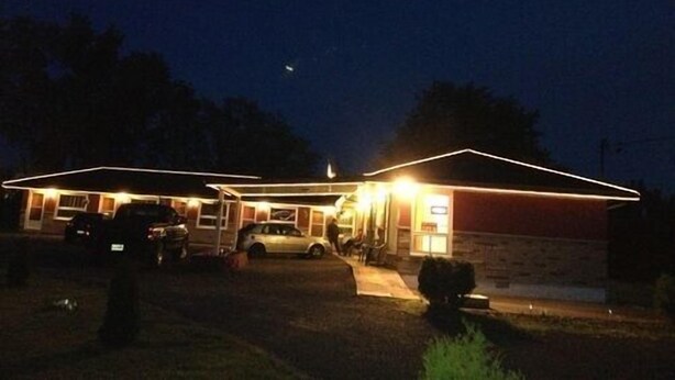 A motel with a simple, two-story structure and a covered parking area. - Sherkston Inn (Port Colborne)