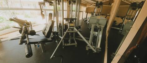 A gym with various exercise equipment, including weight machines and free weights.