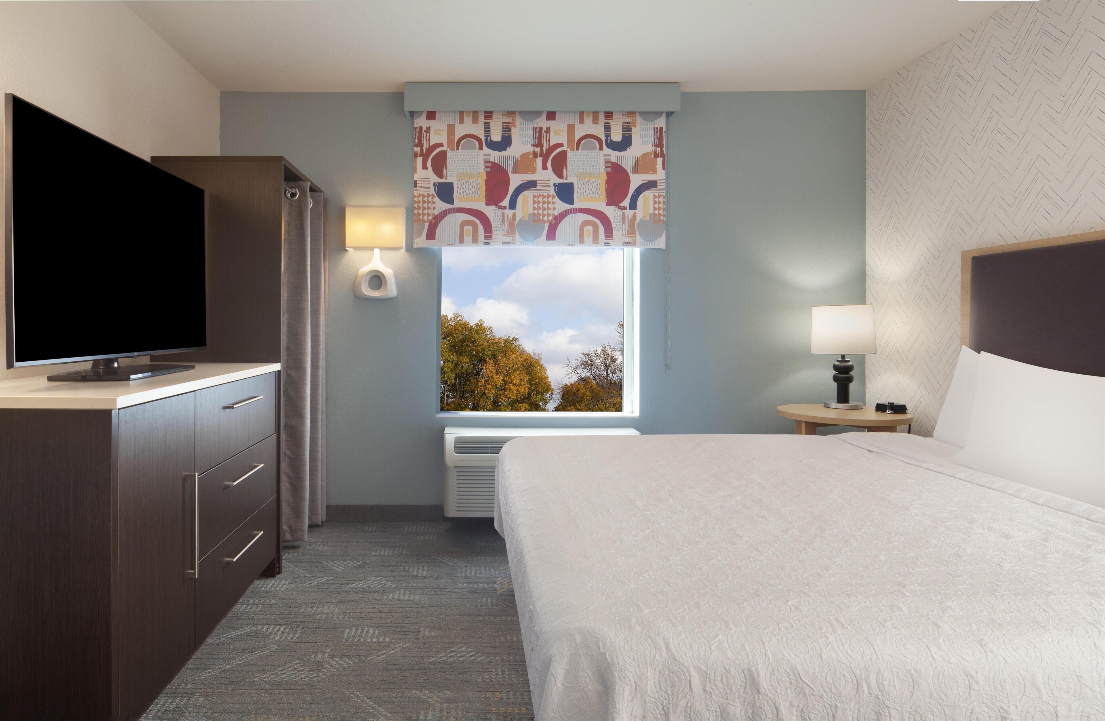 Premium bedding, desk, laptop workspace, iron/ironing board