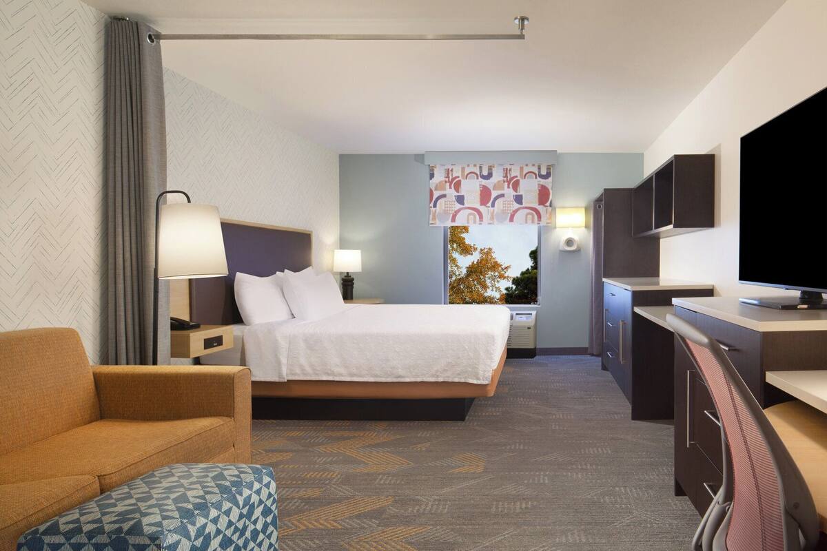 Premium bedding, desk, laptop workspace, iron/ironing board