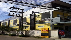 A yellow building with a sign for a pub, a balcony, and a visible entrance. - Lanta Sun Smile Place (Ko Lanta)