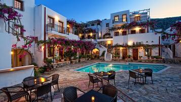 Seasonal outdoor pool, open 10:00 AM to 6:00 PM, pool umbrellas