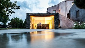 A modern building with a stone facade and a glass entrance. - Ramo d'Aria Etna Boutique Hotel (Giarre)