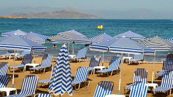 On the beach, sun loungers, beach umbrellas, beach towels