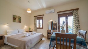 A bedroom with a bed, bedside tables, a desk, a chair, a mirror, and a window with curtains. - Frank Apartments (Malevizi)