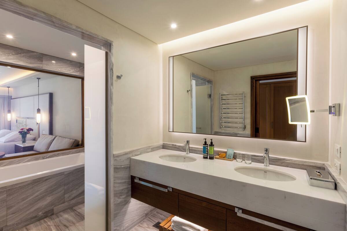 combined shower/bathtub, designer toiletries, hair dryer, bathrobes