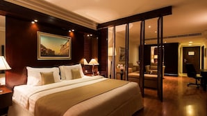 A hotel room with a large bed, two bedside tables with lamps, a sofa, a desk, and a chair. - Best Western Plus Doha (Doha)