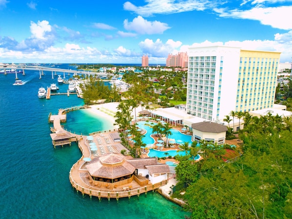 A resort with a large pool, a beach, and a view of the ocean. - Warwick Paradise Island- All Inclusive- Adults Only (Paradise Island)